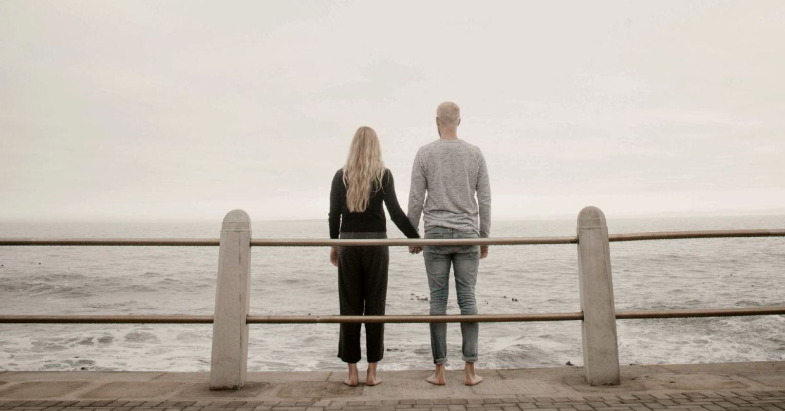 The 3 Most Common Precursors to Divorce Today 1 couple leaning on guard rail while holdings hands facing ocean at daytime by justin groep 4x3 1